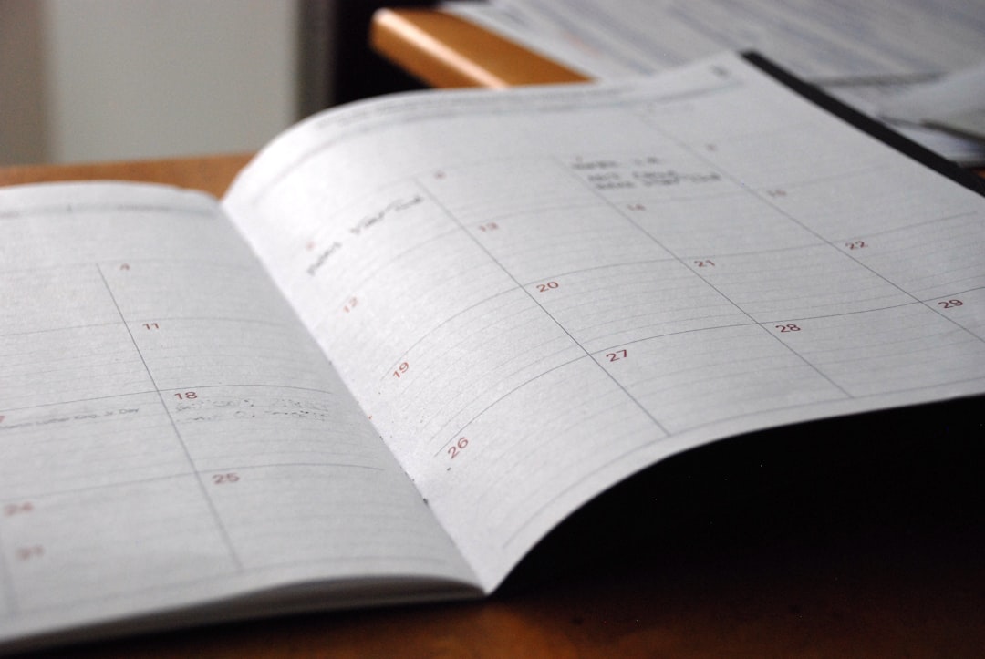 open monthly planner on wooden desk