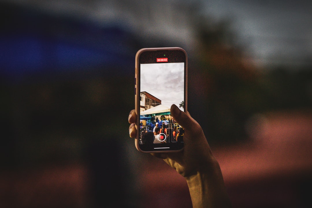 A person taking a picture with a cell phone