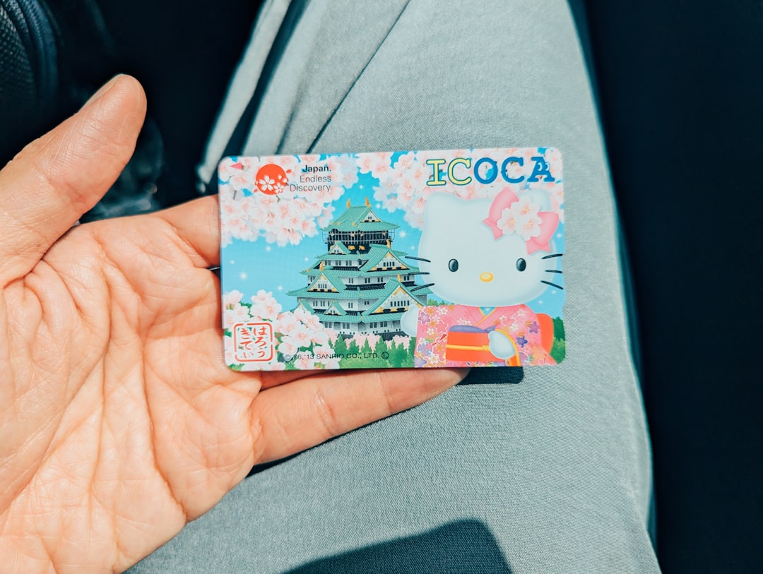 A person holding a hello kitty card in their hand
