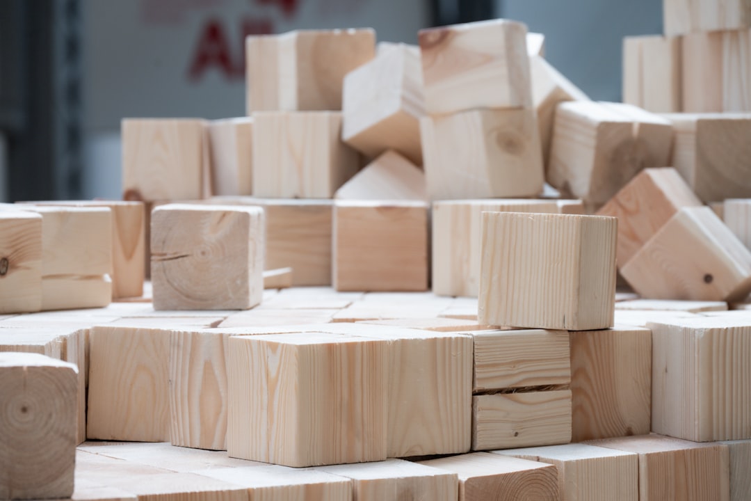 A pile of light wooden blocks stacked and scattered