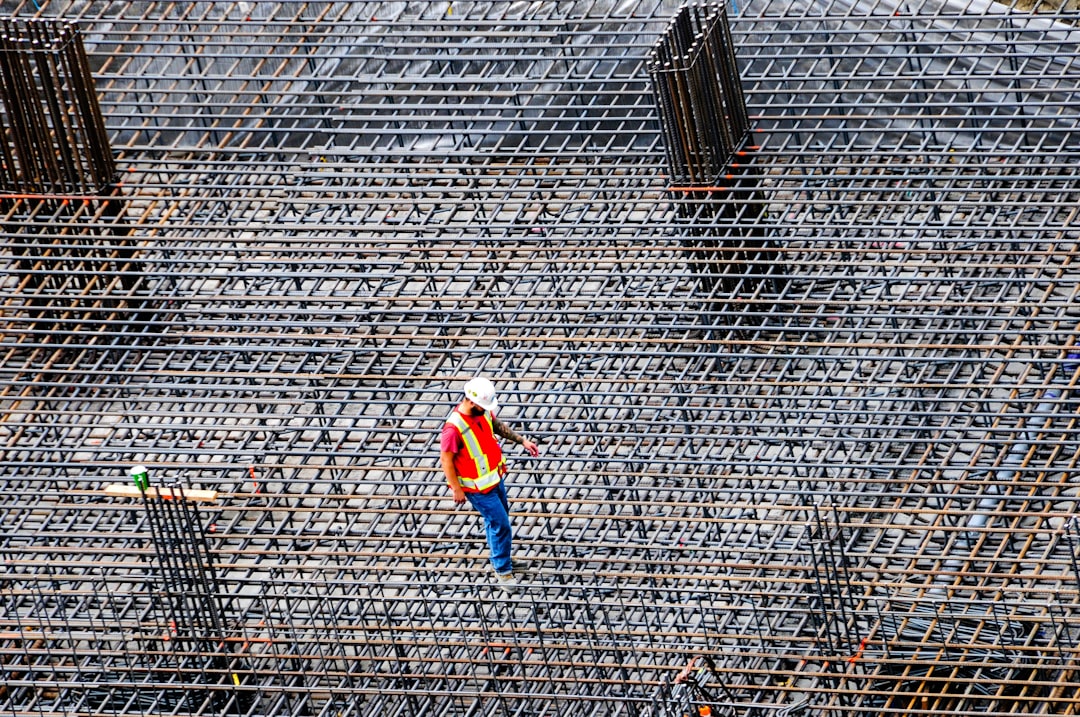 Construction worker inspects rebar on a building site